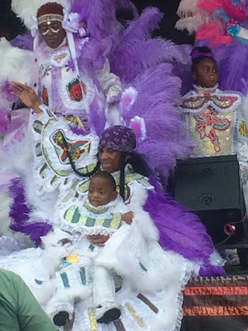 Big Chief Walter Cook, of Creole Wild West, with one of his grandchildren, at the 2016 New Orleans Jazz & Heritage Festival presented by Shell. Photo: Clea Simon
