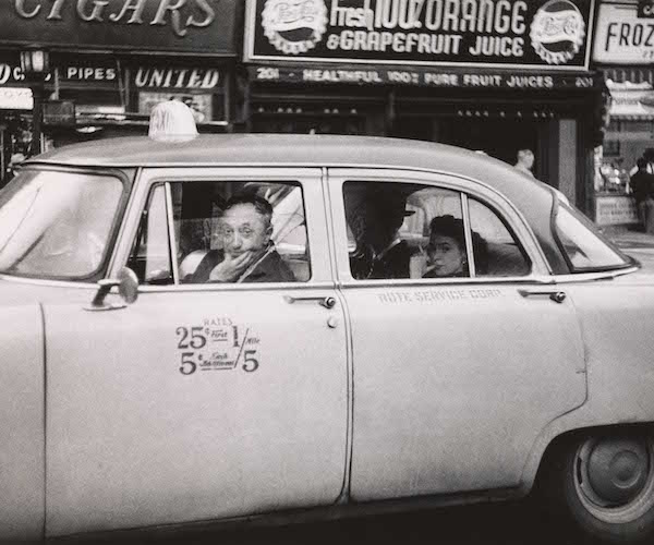 Taxicab driver at the wheel with two passengers, N.Y.C,, 1956, Diane Arbus.