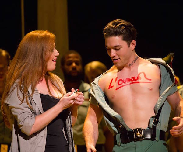 Carmen (Jennifer Johnson Cano) scrawls “love” on the chest of solider Joseph Yonaitis in Boston Lyric Opera’s production of Georges Bizet’s “Carmen." 