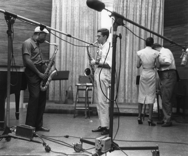 Tenor players Charlie Rouse and Barney Wilen rehearsing at Nola Studio (Nellie Monk is standing at right). 