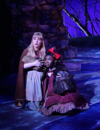  Erica Spyres (Cinderella) comforts Little Red Ridinghood (Maritza Bostic) in “Into the Woods.”